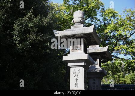 Antike japanische Ishidoro-Steinlaternen mit eingravierten Namen von Fischgroßhändlern auf dem Gelände des Sumiyoshi-Taisha Shinto-Schreins in Osaka Japan. Stockfoto