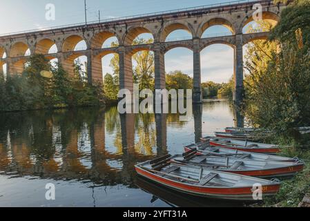 Eisenbahnbrücke mit Fluss in Bietigheim-Bissingen, Deutschland. Herbst. Eisenbahnviadukt über der Enz, erbaut 1853 von Karl von Etzel auf sonniger Basis Stockfoto