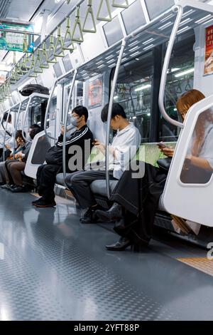 Japaner im Zug schauen Smartphones © Giorgia de Dato Stockfoto