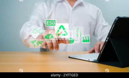 Geschäftsmann analysiert ESG-Symbole für die Nachhaltigkeit von Investitionen. ESG-Umweltschutzkonzept, nachhaltige Entwicklung, Klimawandel, Grüne Energie r Stockfoto