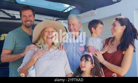 Porträt Der Familie Mehrerer Generationen, Die Das Gepäck Auf Der Rückseite Des Autos In Den Sommerurlaub Lädt Stockfoto