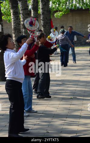 Dutzende Pekinger, die verschiedene Formen der Bewegung im großen Pekinger Park, der den Tempel des Himmels umgibt, ausüben. Stockfoto