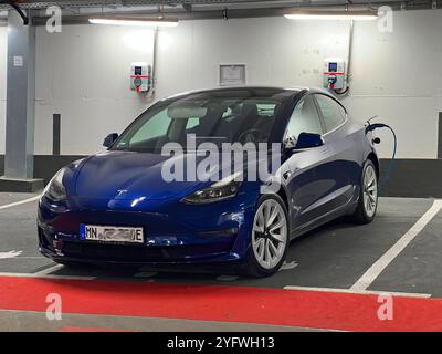 05.11.2024, Bad Wörishofen Unterallgäu, eine Ladesäule für E-Autos in der Tiefgarage. Ein blauer TESLA Model 3 steht beim Laden auf dem Parkplatz. 05.11.2024, Ladesäule 05.11.2024, Ladesäule *** 05 11 2024, Bad Wörishofen Unterallgäu, eine Ladestation für Elektroautos in der Tiefgarage Ein blaues TESLA Model 3 lädt auf dem Parkplatz 05 11 2024, Ladestation 05 11 2024, Ladestation Stockfoto