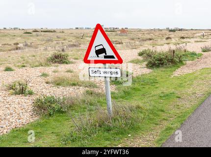 Dreieckiges Straßenwarnschild in Fahrzeugform, um den Fahrer vor weichen Kanten zu warnen. Dies ist im Vereinigten Königreich zu finden. Stockfoto