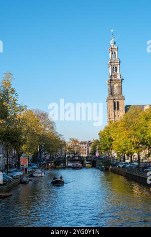 Amsterdam 23. Oktober 2024, Herbst zeichnet eine malerische Szene entlang der ruhigen Kanäle Amsterdams, wo lebhafte Bäume die Küste säumen und Boote gleiten Stockfoto