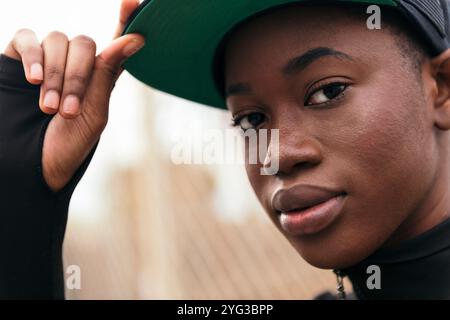afroamerikanerin passt ihre Kappe an Stockfoto