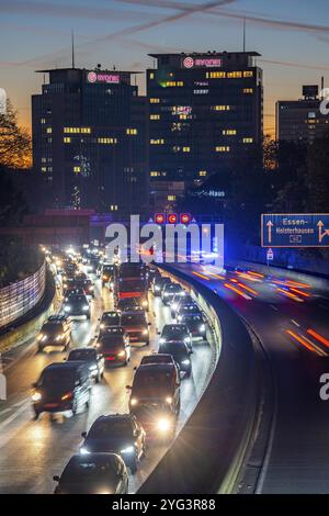 Abendverkehr, teilweise mit Staus, langsam fahrender Verkehr auf der Autobahn A40, Essener Skyline, Evonik Group Hauptsitz, Essen, Nordrhein-Westp Stockfoto