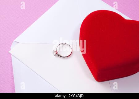 Diamantring und kleine Box mit rotem Herzen Stockfoto