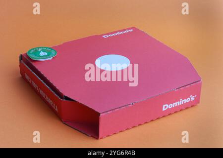 London, Vereinigtes Königreich, 5. November 2024:- Ein Blick auf Dominos 9' Pizza, vor orangefarbenem Hintergrund Stockfoto