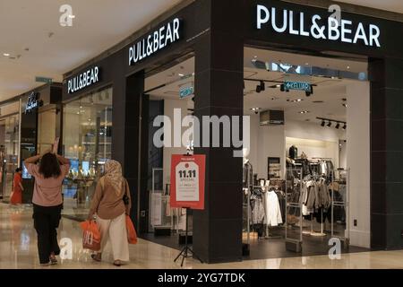 Kuala Lumpur, Malaysia. November 2024. Leute, die an einer Pull&Bear Boutique in einem Einkaufszentrum vorbeikommen sehen. (Foto: Faris Hadziq/SOPA Images/SIPA USA) Credit: SIPA USA/Alamy Live News Stockfoto