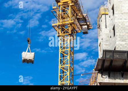 Crane transportiert einige Produkte auf einer Baustelle in einer Stadt in Brasilien Stockfoto