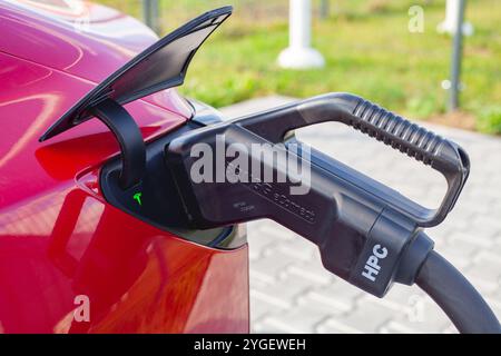 Rotes, vollelektrisches amerikanisches Auto Tesla Model 3 Dual Motor verfügt über eine Schnellladestation in litauen Stockfoto