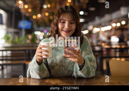 Porträt der schönen und jungen süßen thailändischen asiatischen Frau, die im Cafe Restaurant Kaffeepause macht Stockfoto