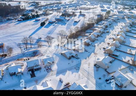 Amerikanische Wohngebiete im Winter mit frischem Schnee bedeckt, mit weißen Häusern, Parkplätzen, Straßen, ruhiger Schönheit des Winters. Stockfoto