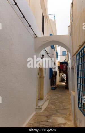 Straße in Medina in Sousse, Tunesien. Mittelalterliche Stadt Hammamet mit farbenfrohen Wänden und Haus mit kleinen privaten orientalischen Souvenirläden Stockfoto