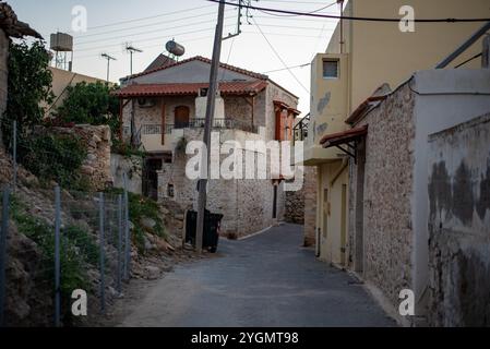 Enge griechische Gassen in Hersonissos, Kreta, Griechenland, gesäumt von bezaubernden weiß getünchten Gebäuden, bunten Blumen und lebhaften lokalen Geschäften, die Saibling ausstrahlen Stockfoto