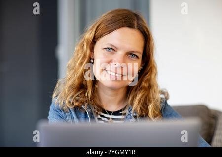 Porträt einer jungen schönen Frau mit lockigen gelben Haaren Stockfoto