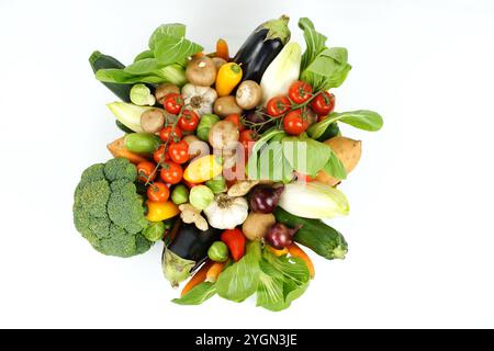 Rohes gemischtes Bio-Gemüse von oben fotografiert, isoliert auf weißem Hintergrund. Enthält Brokkoli, Pac Choi, rote Zwiebeln, Knoblauch, Rosenkohl Stockfoto