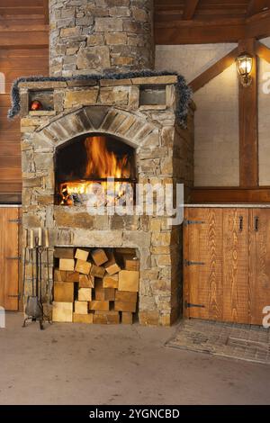 Ofen mit brennendem Brennholz zum Grillen in der Restaurantküche Stockfoto