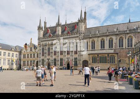 Touristen vor dem historischen Rathaus Stadhuis von 1376 in der Altstadt von Brügge in Belgien Stockfoto