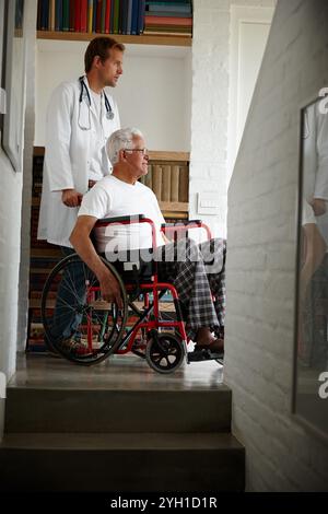 Arzt, Seniorenmann und Rollstuhl am Fenster mit Reflexion, Gedächtnis und Denken mit Erholung. Arzt, Patient oder ältere Menschen mit Behinderung Stockfoto