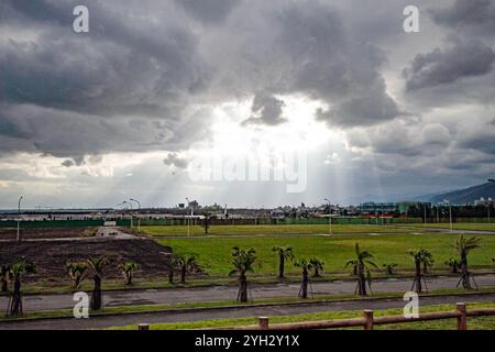 Lichtstrahlen brechen durch stürmische Wolken über der Farm Stockfoto