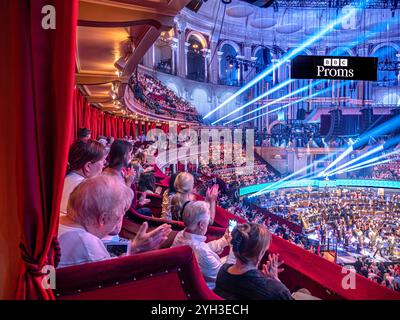 PROMS in der Royal Albert Hall Publikum applaudiert klatschende BBC Promenade Konzerte Aufführungseinrichtung aus luxuriösem Plüschkasten im Auditorium mit Sound und spektakulären Lichteffekten. Proms Promenade Konzerte Royal Albert Hall Kensington London UK Stockfoto