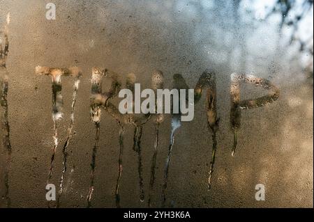 Das Wort Trump steht auf nassem Glas. Das Konzept Stockfoto