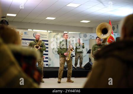 Odessa, Ukraine. November 2024. Zuschauer sehen die Auftritte von Musikern des Konzertorchesters der Odessa Military Academy, Brass Band „Guten Abend“ in der Lobby des Chornomorets Stadions. Aufführung von Musikern des Konzertorchesters der Odessa Military Academy, Brass Band „Guten Abend“ in der Lobby des Chornomorets Stadions. Ziel ist es, die Moral der Bevölkerung während der militärischen Aggression der Russischen Föderation zu unterstützen. Quelle: SOPA Images Limited/Alamy Live News Stockfoto