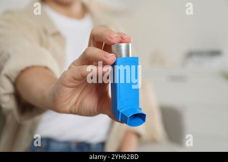 Frau hält Inhalator drinnen, Nahaufnahme. Asthmabehandlung Stockfoto