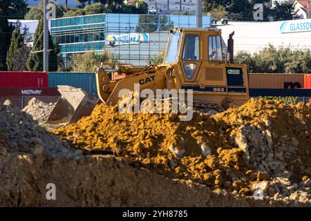 Gelber Kettenlader caterpillar 963, der Schmutz auf einer Baustelle bewegt Stockfoto