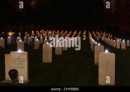 November 2024. Gedenksonntag auf dem Aldershot Military Cemetery in Hampshire, England, Großbritannien. Die jährliche Zeremonie „Beleuchtung der Gräber“ fand am Abend statt. 692 wurden die Gräber des Ersten Weltkriegs mit einer Kerze geschmückt, als ein Moment der ergreifenden Reflexion, um an die Kriegstoten zu erinnern und zu ehren. Stockfoto