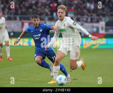 Augsburg, Deutschland. November 2024. Arne Maier (R) vom FC Augsburg streitet mit Umut Tohumcu von der TSG Hoffenheim beim Fußball-Erstliga-Spiel zwischen dem FC Augsburg und der TSG Hoffenheim am 10. November 2024 in Augsburg. Quelle: Philippe Ruiz/Xinhua/Alamy Live News Stockfoto