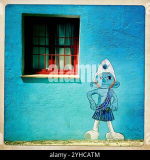 A painting of a smurf dressed with the Scotland's national dress decorates a wall in Juzcar, Malaga province, Andalusia, Spain, May 13, 2012. Juzcar has been painted blue recently Stock Photo