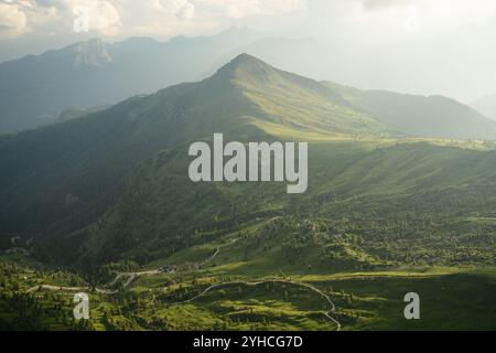 Sommerblick vom Monte Nuvolau aus mit sanften grünen Hügeln und Berggipfeln in den Dolomiten. Das Sonnenlicht beleuchtet die Landschaft sanft Stockfoto