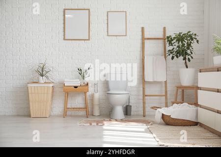Innenseite der Toilette mit Toilettenschüssel, Leiter und Wäschekorb Stockfoto