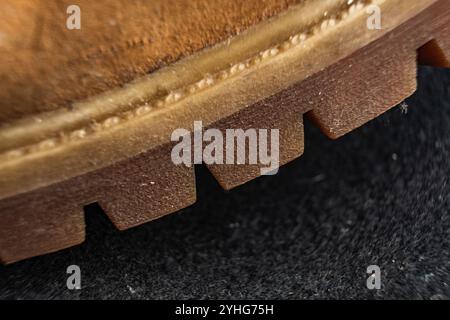 Nahaufnahme der Schuhsohle, die Textur und Profil vor dunklem Hintergrund freigibt Stockfoto