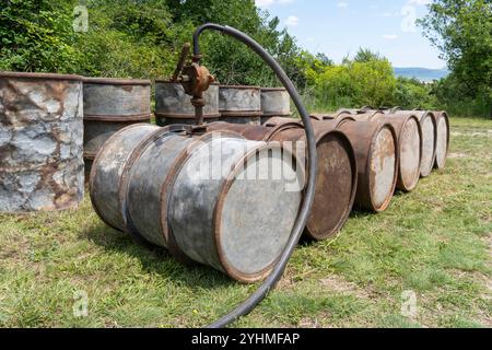 Rostige alte Metallölfässer in Außenlagerung Stockfoto