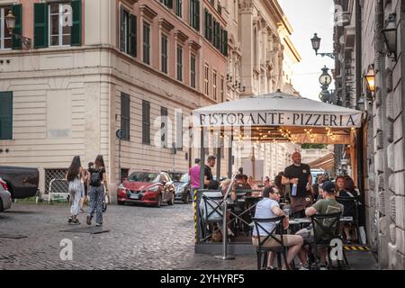 ROM, ITALIEN - 15. JUNI 2024: Die Gäste können auf der Terrasse eines traditionellen Pizzeria-Restaurants in der Altstadt speisen und dabei die Essenz des italienischen Cuis einfangen Stockfoto