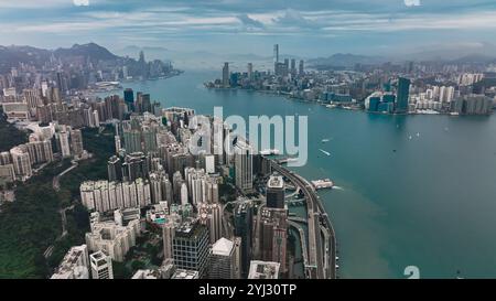 Das Panorama fängt die pulsierende Skyline von Hongkong neben den ruhigen Gewässern der Victoria Bay ein und unterstreicht die dynamische Mischung der Natur Stockfoto