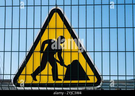 Warnschild „arbeitet voraus“ auf einer Straße. Bauwarnschild. Straßenschild auf der Straße. Straßenarbeiten, horizontal, keine Leute. Schild für Straßenbauarbeiten für Constru Stockfoto