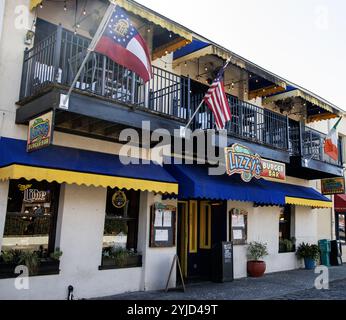 Savannah, Georgia, USA - 20. Februar 2024: Die lebhafte Burger-Bar bietet helle Farben, Flaggen und einladende Sitzplätze im Freien in einem belebten Bereich. Stockfoto