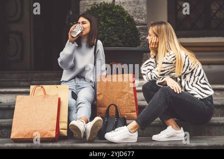 Zwei junge kaukasische Frauen, die Spaß auf der Stadtstraße im Freien haben, beste Freunde, die einen gemeinsamen Feiertag genießen, fröhlicher Lebensstil, Jugendliche und junge Frauen Stockfoto