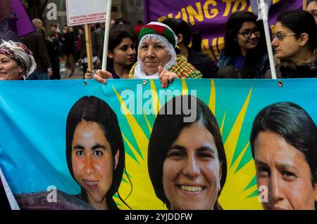 London, Großbritannien. März 2018. Kurdische Frauen marschieren hinter einem Banner durch London, das die Kämpferinnen in Syrien unterstützt, auf dem vormarsch gegen männliche Gewalt gegen Frauen, Teil der Million Women Rise Bewegung gegen die globale Pandemie männlicher Gewalt gegen Frauen. Viele trugen feministische Plakate und es gab Gruppen verschiedener Frauenorganisationen im ganzen Land, darunter auch aus verschiedenen ethnischen Gemeinschaften. Sie marschierten entlang der Oxford Street zu einer Kundgebung am Trafalgar Square. Stockfoto