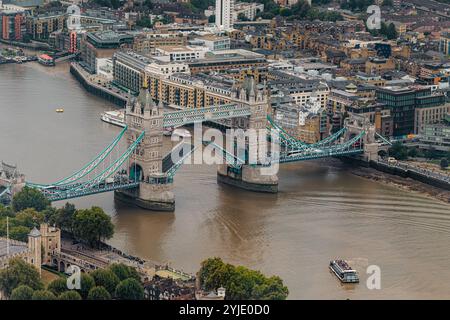 Ein Blick aus der Luft auf die Tower Bridge, die hoch ist, um große Schiffe hinunterfahren zu lassen, wurde 1890 fertiggestellt und ist eines der bekanntesten Wahrzeichen Londons. Stockfoto