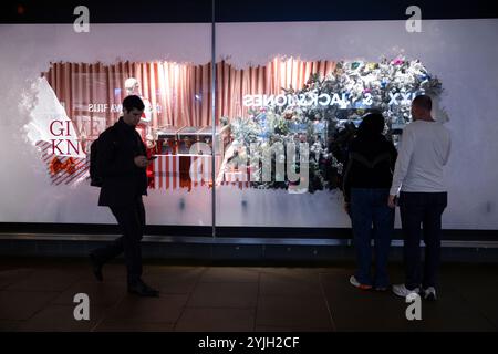 Weihnachtseinkäufer genießen die John Lewis 2024 Weihnachtsfenster zu Beginn der Feiertage entlang der Oxford Street, Großbritanniens geschäftigster Straße. Stockfoto