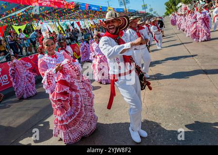 Kolumbianische Paare, die traditionelle Cumbia-Outfits tragen, tanzen die Cumbia während der Parade des Karnevals in Barranquilla, Kolumbien. Stockfoto