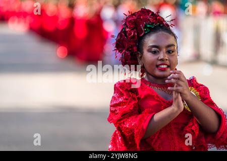 Eine afro-kolumbianische Frau, die ein traditionelles Cumbia-Outfit trägt, tanzt die Cumbia während der Parade des Karnevals in Barranquilla, Kolumbien. Stockfoto