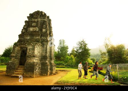 Kinder, die sich im Bima-Tempel, einem alten Hindu-Tempel auf dem Dieng-Hochplateau, der administrativ in Dieng Kulon, Batur, Banjarnegara, Zentral-Java, Indonesien, liegt, Freizeit haben. Stockfoto