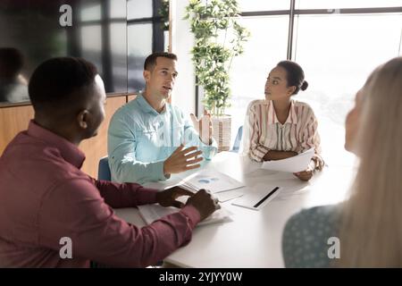 Unterschiedliche Gruppe junger Geschäftsleute, die ein Brainstorming zur Marketingstrategie durchführen Stockfoto